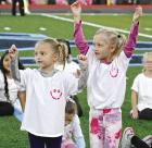 Maddyn Hickey (left) and Caina Kielmann joined with other participants in the Little Beaver cheer camp for a halftime performance on Saturday during the SCHS vs Holcomb football game. (Record Photo) Maddyn