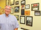 Randy Huck in front of his “wall of memories” while serving as a SCHS coach and activities director. (Record Photo) Second career as teacher, SCHS AD coming to a close for Huck