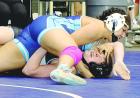 (Above) Scott City’s Amya Parker waits for the official to award a fall during a consolation round win over Katie Purcell (Holton) in the 120-pound division. (Right) Brodi Speer, a 135-pound senior, wins by a fall over Ariana Unruh, Jefferson West. (Bel