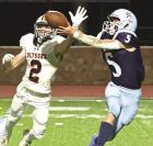 SCHS runningback Peyton Bergner grabs a pass that’s just beyond the reach of Ulysses defender Preston Hittle which resulted in a 40 yard touchdown during last Friday’s GWAC win. (Record Photo)