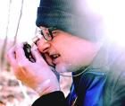 John Brinda, a bryophyte researcher with the Missouri Botanical Garden, gets a closer look at a piece of moss at the Shaw Nature Reserve in Gray Summit, Mo.