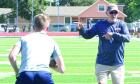 College coach Courtney Messingham SCHS runningbacks through ball security drills during the two-day clinic. (Record Photo) it’s still the details