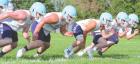 Scott Community High School offensive linemen fire off as they spent a good deal of their time during summer camp working on blocking technique. (Record Photo) Article Image Alt Text