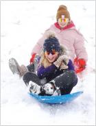 Recent snow storms meant an extended holiday break for area students and a chance to enjoy some outdoor fun. Sledding at Maddux Park in Scott City were 12-year-old Hadleigh Ames (front) and 13-year-old Sophia Goode. (Record Photo