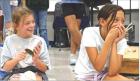 Scott City Middle School fifth graders Hartley Berry (left) and Ashley Myers share a laugh as they perform as part of Thad Beach’s bucket band last Friday morning. Beach conducted a weeklong musical residency at SCMS, sponsored by the Scott County Arts 