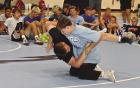 Jacob Frost throws his brother, Evan, to the mat while demonstrating a takedown during last week’s wrestling camp in Scott City. (Record Photo)
