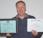 Dustin Turley with certificates of honor he has received from Northcentral University and Delta Mu Delta honor society. Article Image Alt Text
