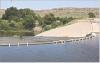 Since July 31, PVC pipe has been siphoning water from Lake Scott at the spillway with plans to eventually draw down the lake level by three to five feet. (Record Photo)