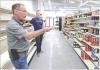 Randy Evans (foreground) and Casey Venters, director of the Lane County Community Foundation, discuss the work that’s being done to prepare the grocery store for its grand opening on June 27. (Record Photo)
