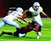 SCHS quarterback Drew Metzger avoids a tackle by a Great Bend defender as he breaks loose for a nine yard run during last Friday’s season opener. (Record Photo)