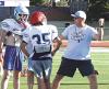 SCHS head coach Jim Turner explains how he wants offensive linemen to take the defender out of the play during Monday’s camp. (Record Photo)