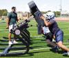 SCHS assistant coach Drew Kite encourages the linemen as they work out on the blocking sled during the opening day of practice on Monday. (Record Photo)