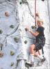 Harrison Harms, 10, Scott City, tries to find his footing while scaling the rock wall that was among the many attractions at the Scott County Fair last Thursday. (Record P hoto)