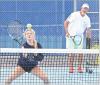 Allie Plummer prepares to hit a return shot at the net while longtime coach and clinician Dave Hawley looks on during the Scott City tennis camp. (Record Photo)