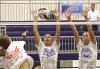Kayden Holstein (left) and Katie Weathers combine for a block during action against Dighton on Monday in the Beaver Bash. (Record Photo)