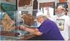 Chuck Bonner and Barbara Shelton pose with two xiphactinus skulls protected in glass which are a popular attraction at the Keystone Gallery. (Record Photo)